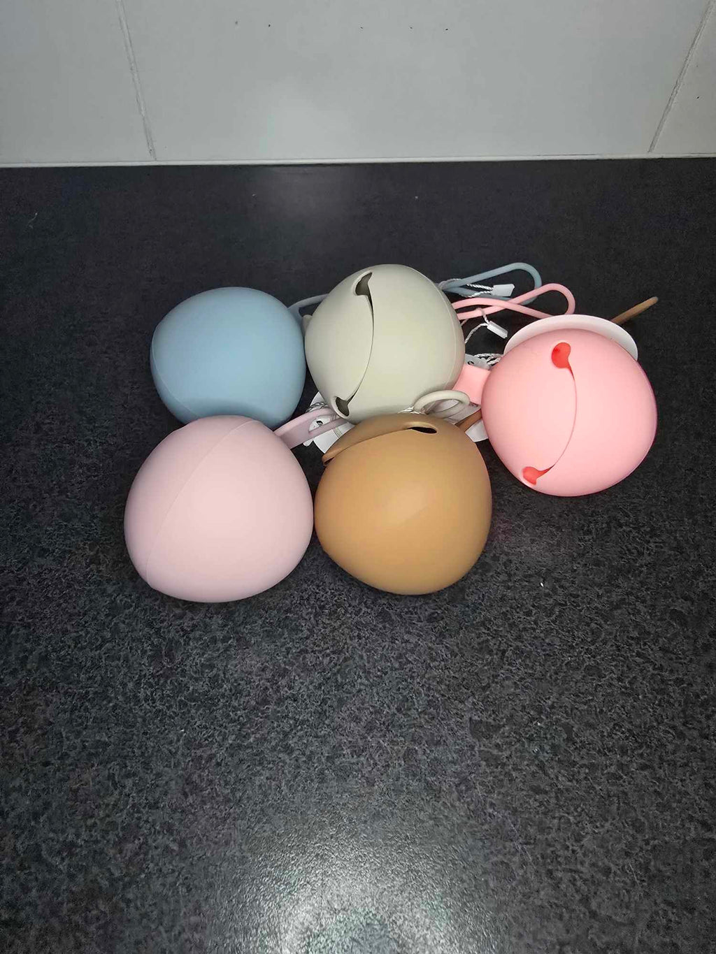 Five colorful dummy holders  on a dark surface