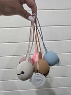 Set of colorful dummy holders held by a hand on a light wooden surface