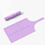 Purple silicone mat with handle on a white background