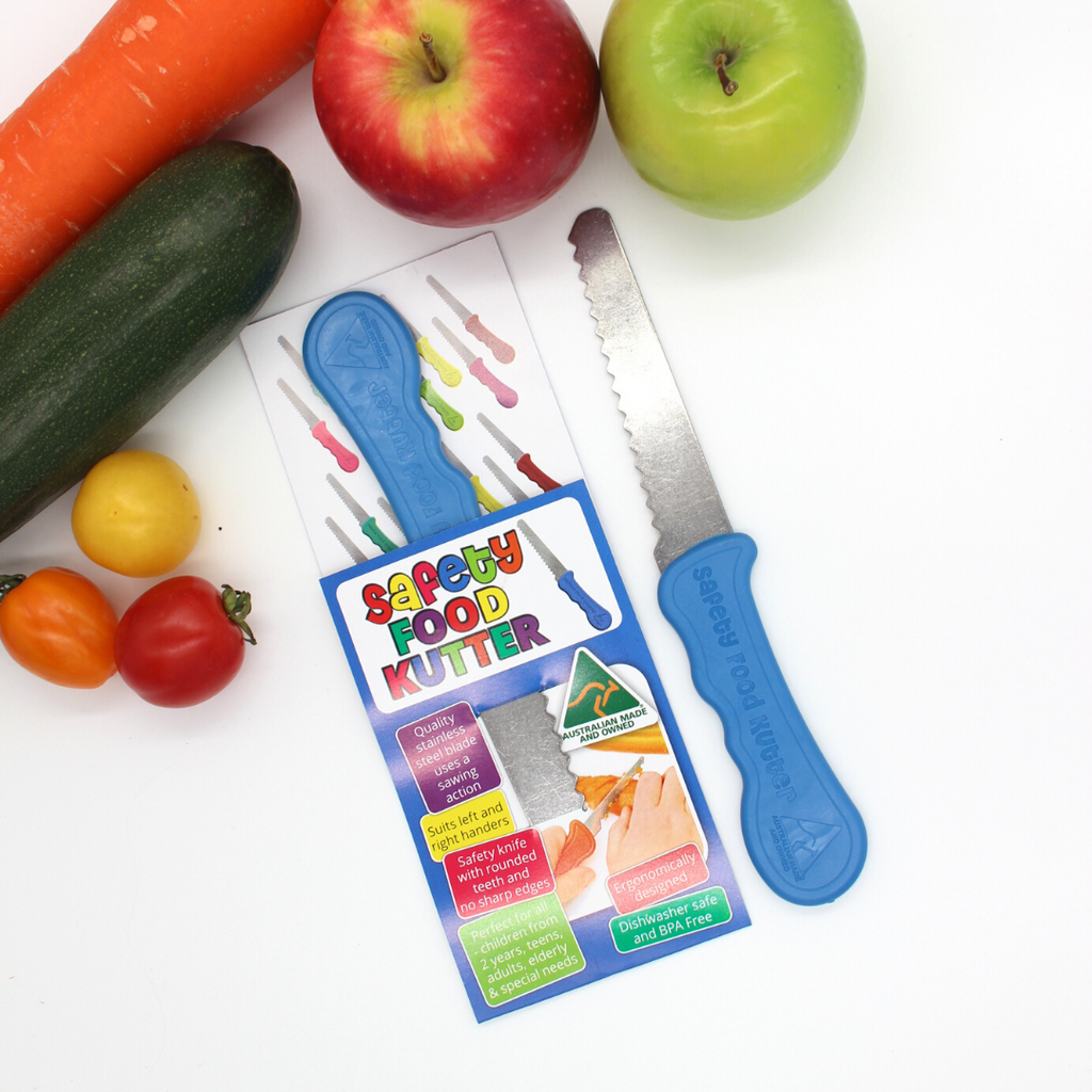 Safety Food Cutter with packaging on a white background with vegetables and fruits.