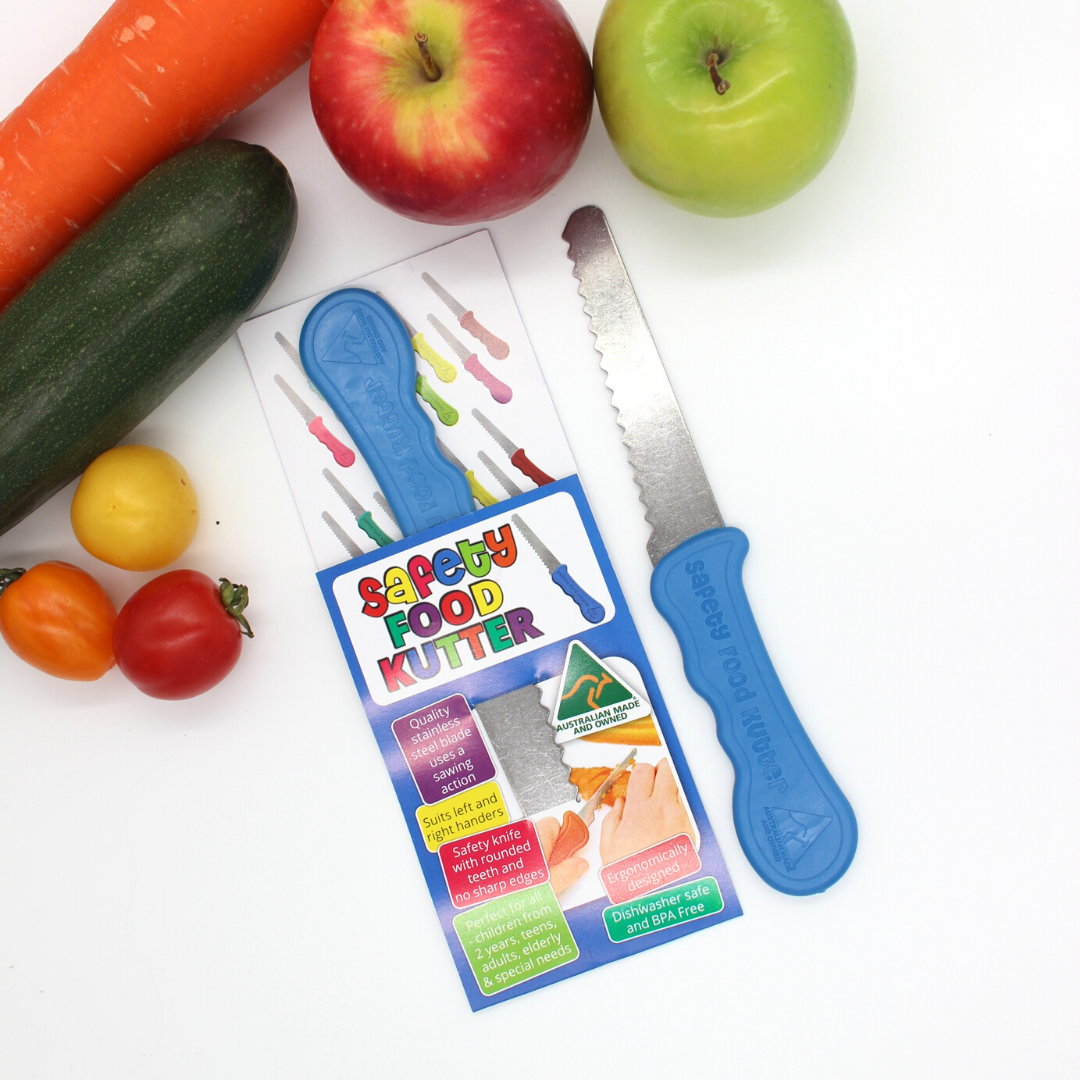 Safety Food Cutter with packaging on a white background with vegetables and fruits.