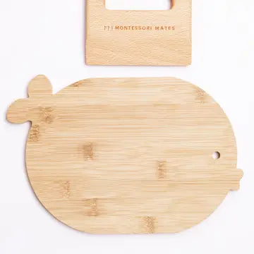Wooden turtle-shaped cutting board with a brand tag on a white background