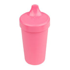 Pink sippy cup on a white background