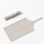 Beige cutting board with handle and rolling pin on a white background