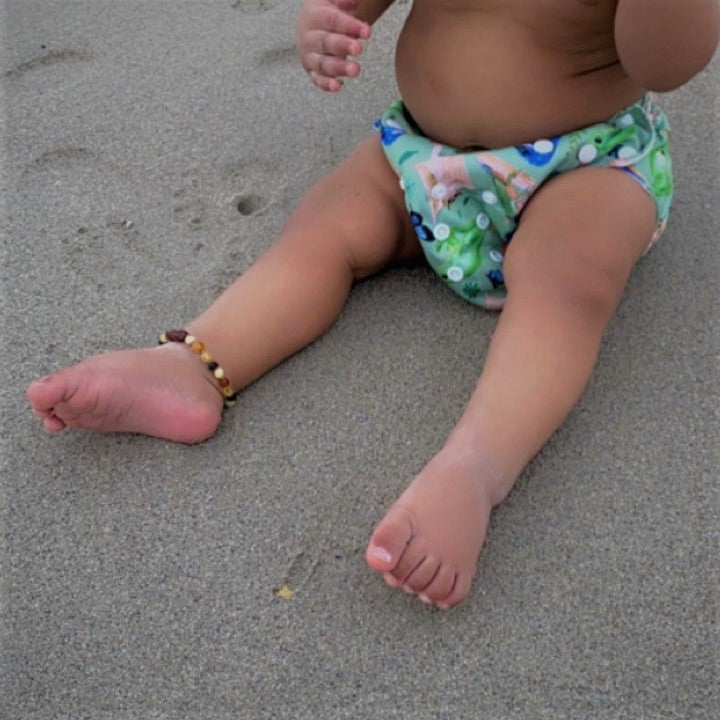 Green Reusable Swim Nappy on the beach