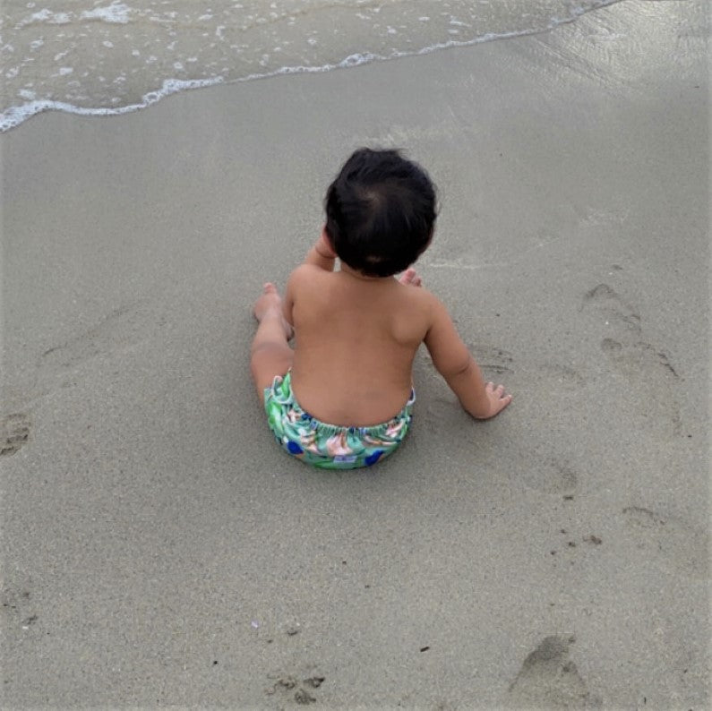 Reusable Swim Nappy & Mini Wet Bag Combo green at the beach