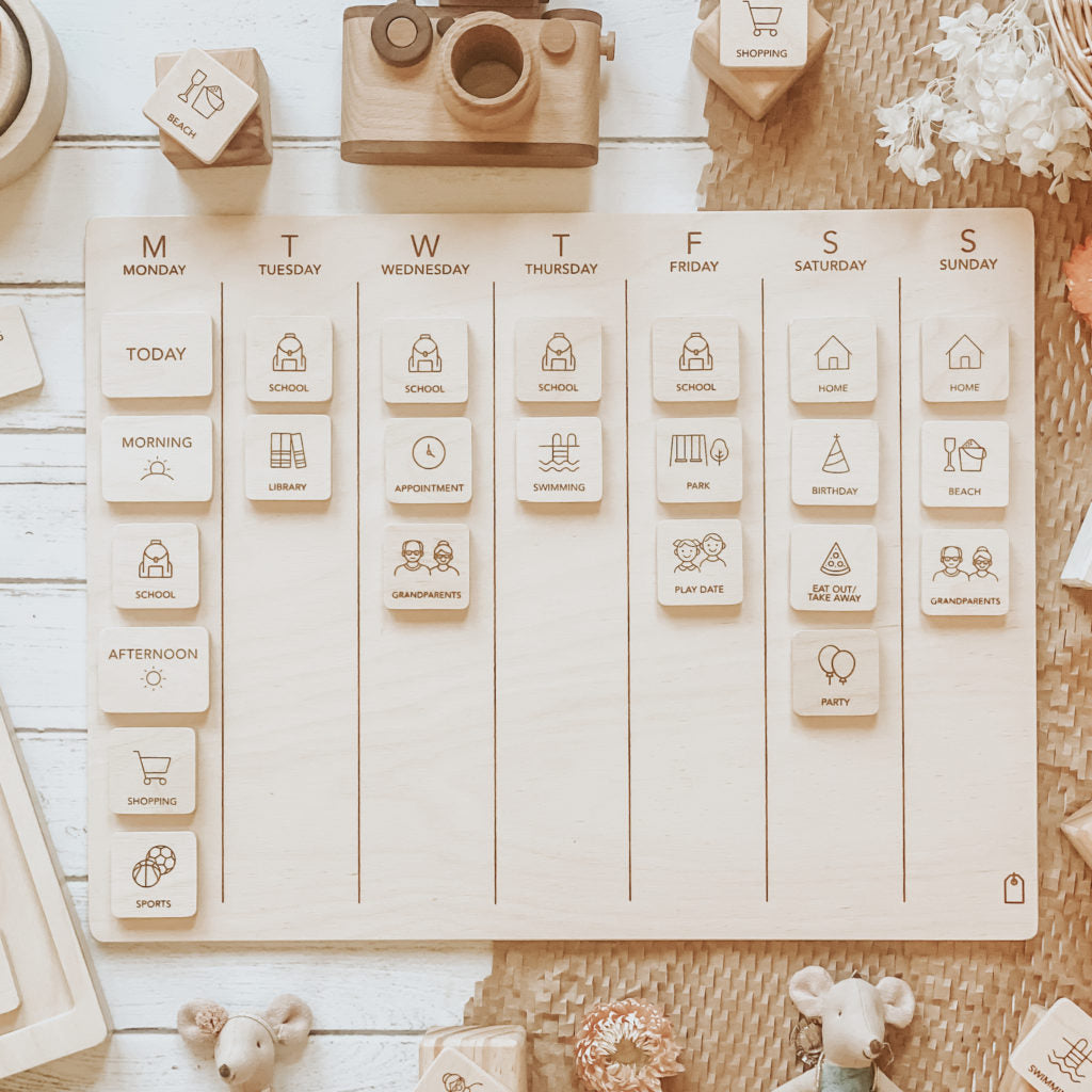 Wooden daily planner with icons on a wooden surface