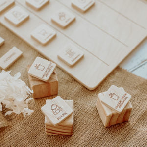 Wooden blocks with printed designs on a textured surface next to a keyboard