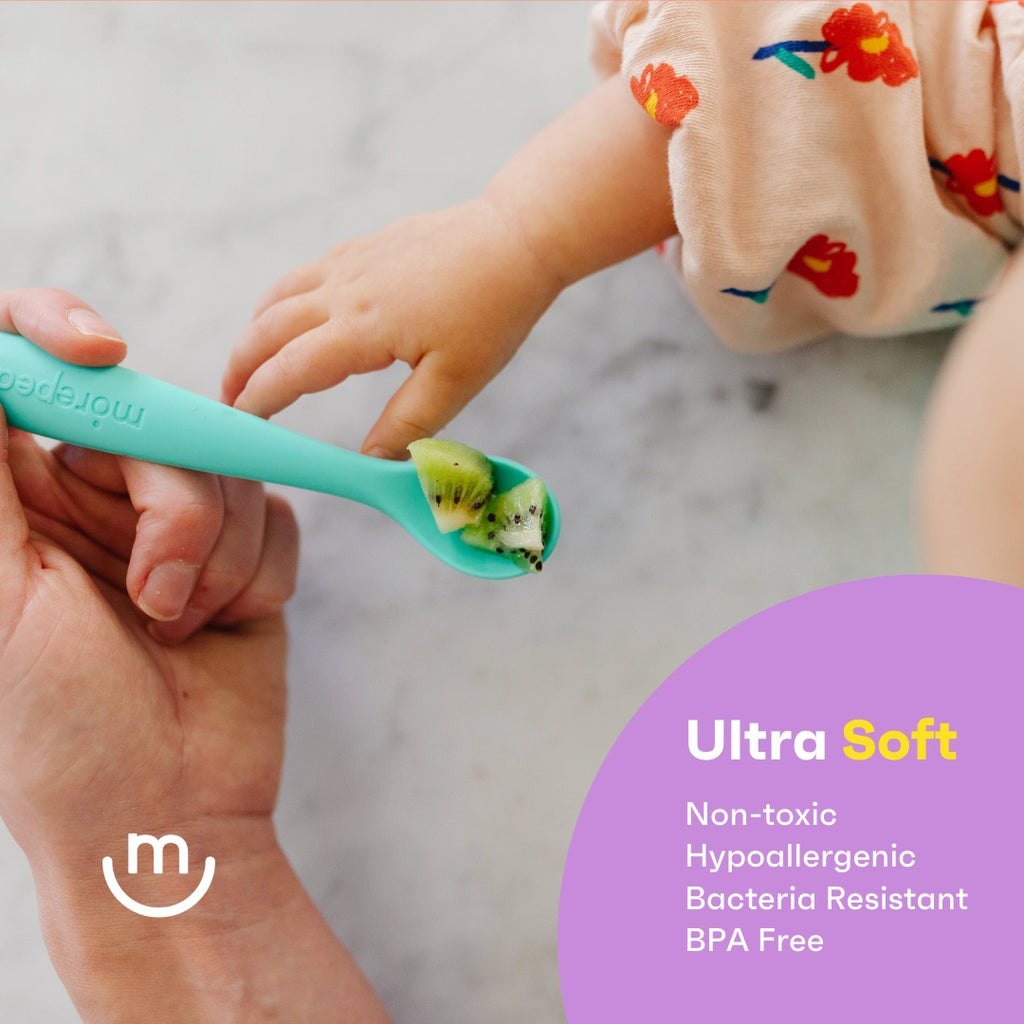 Person holding a teal spoon with a baby's hand, featuring a brand logo and product benefits text.
