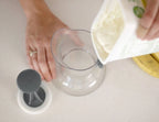 Person pouring ingredients into a Kids Pouch Filling Station on a kitchen counter