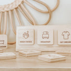 Set of wooden blocks with icons and text on a wooden surface