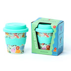 Children's reusable cup with animal pattern and matching packaging on a white background