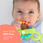 Baby holding a colorful teething toy with text about safety features on a white background