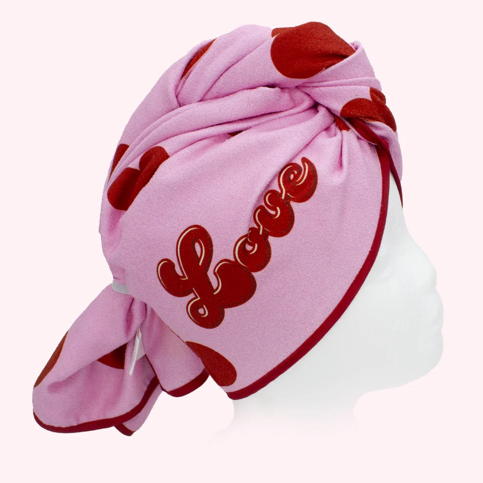 Pink head towelwith red hearts and 'LOVE' text on a white background