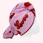 Pink head towelwith red hearts and 'LOVE' text on a white background