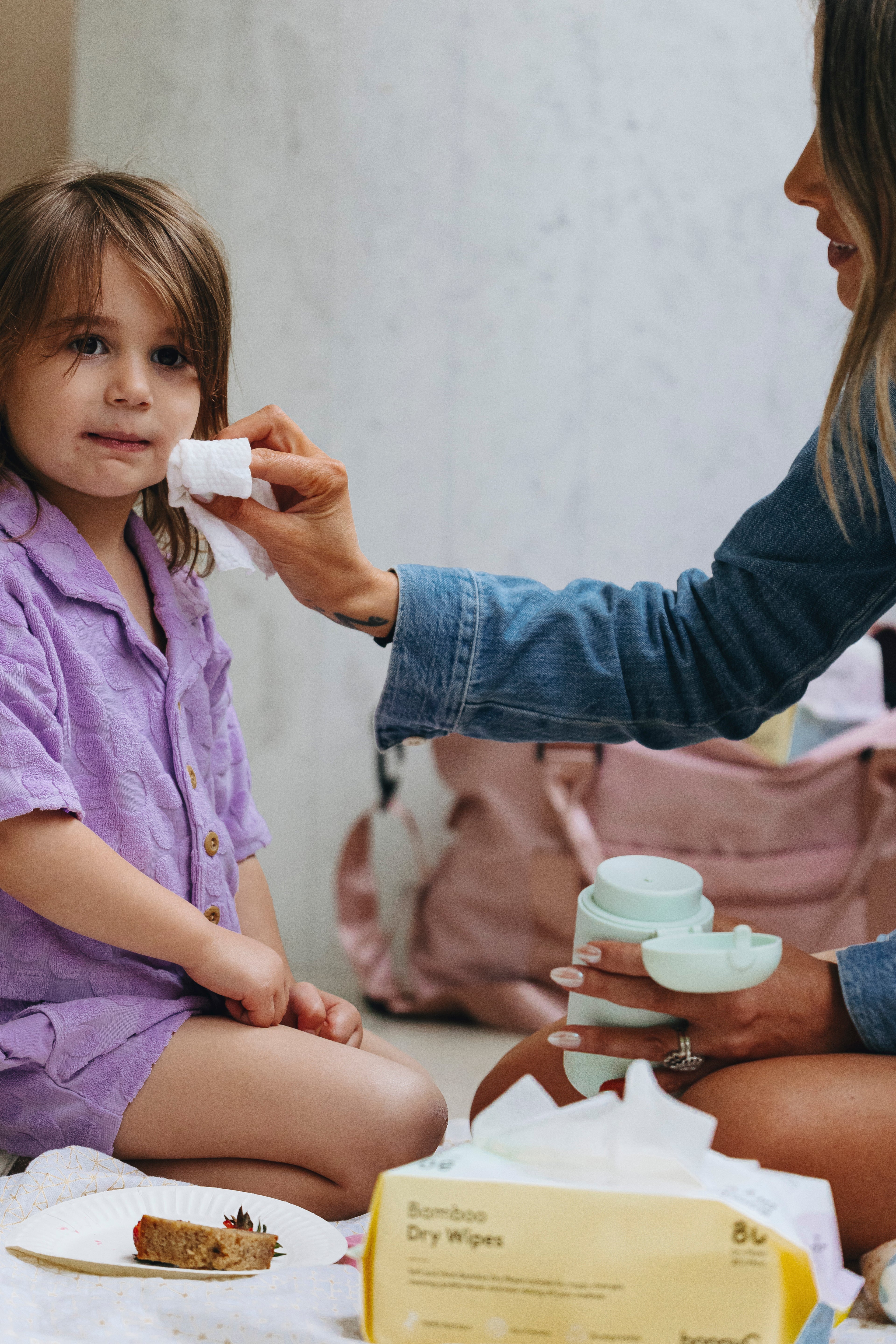 Woman using wipes dispenser and bamboo wipes.