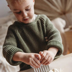 Child wearing a green knitted sweater using a Kids Crinkle Cutter